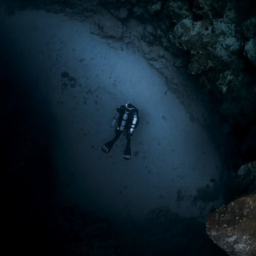 Technical diver on CCR Liberty checking handset electronics and PO2 readings underwater to prevent human error.