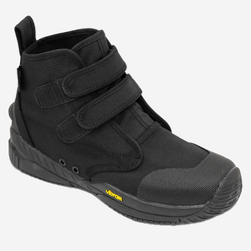 Black high-top sneaker with velcro straps on a white background