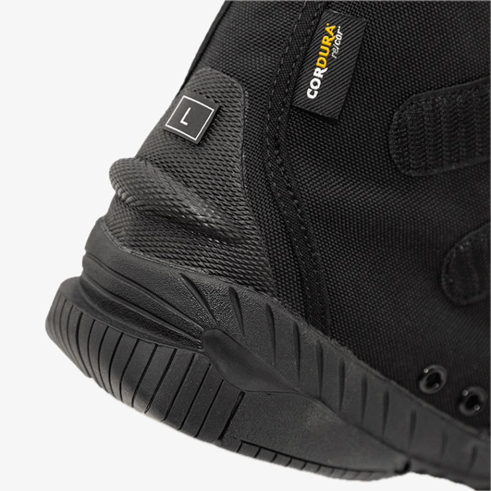 Black high-top sneaker with velcro straps on a white background