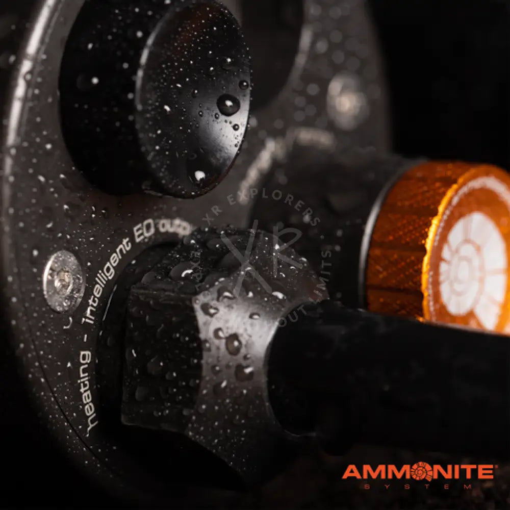 Black and orange ammonite system fishing reel accuthermo type 24 with matte finish and engraved text on the side