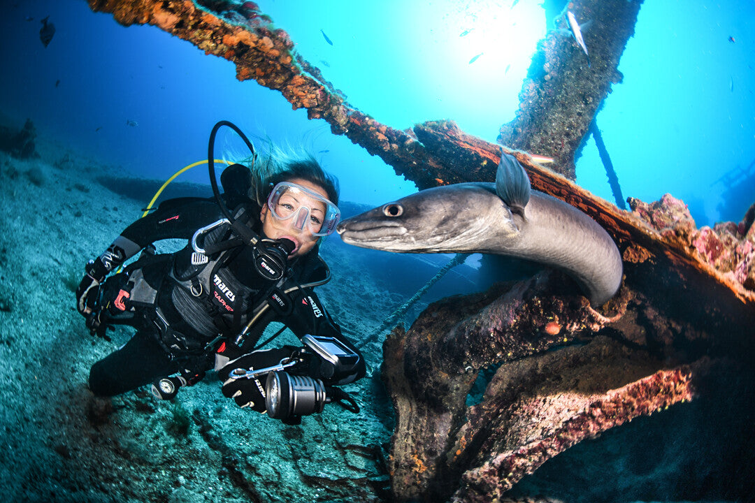 Promotional image for SSI Advanced Adventurer diving course featuring divers exploring a coral reef environment.