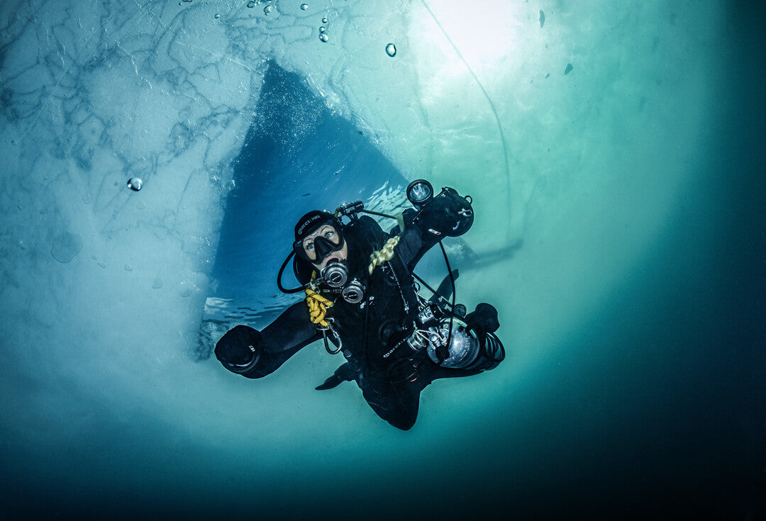 Student in DIR configuration practicing perfect trim during decompression under Ice