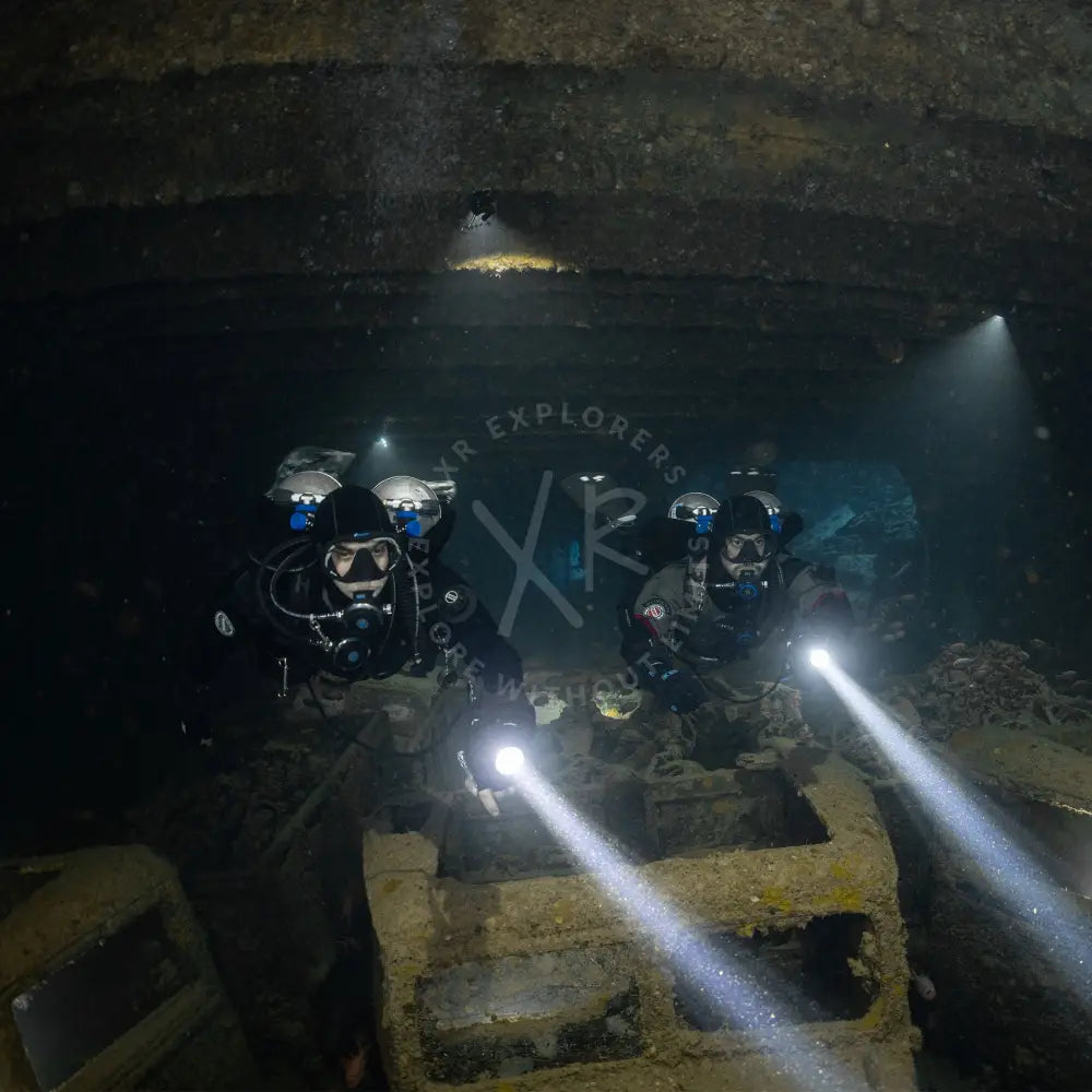 GUE team divers underwater with double tanks gue equipments configurations in ss thistelgom wreck in the red sea