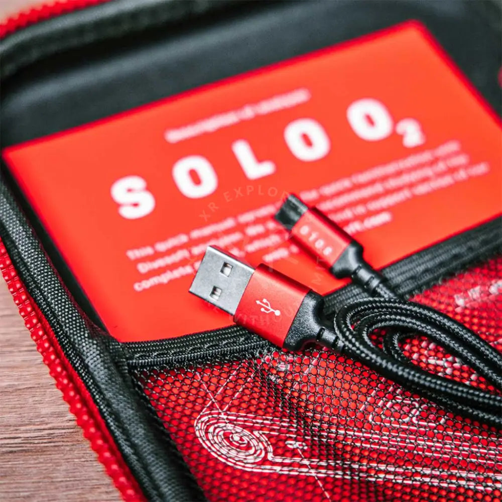 Red usb cable with black braided cord and metallic connectors in red mesh pouch for divesoft analyzer SOLO O2 nitrox analyzer