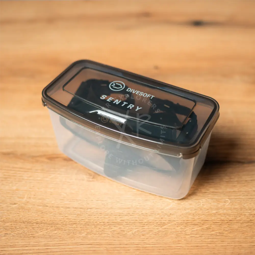 Clear plastic container with black lid labeled divesoft sentry for storing divesoft sentry frameless mask with neoprene strap
