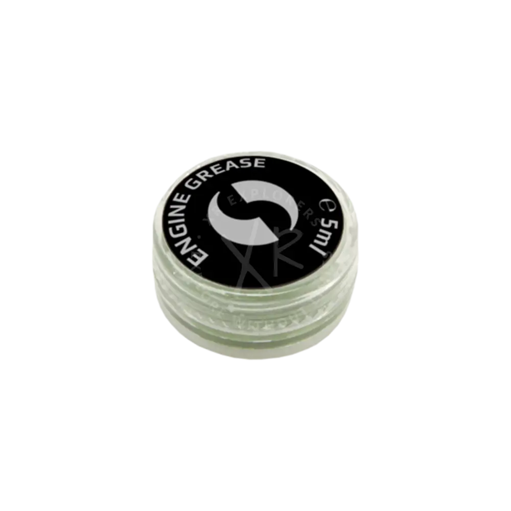A small clear plastic container with a black lid labeled engine grease for drive system grease 5 ml