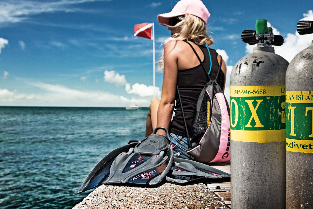 A promotional image featuring a diver in an underwater setting with fish in the background, showcasing the SSI Enriched Air Nitrox course. The diver is equipped with scuba gear and the text 'ENRICHED AIR NITROX' is prominently displayed.