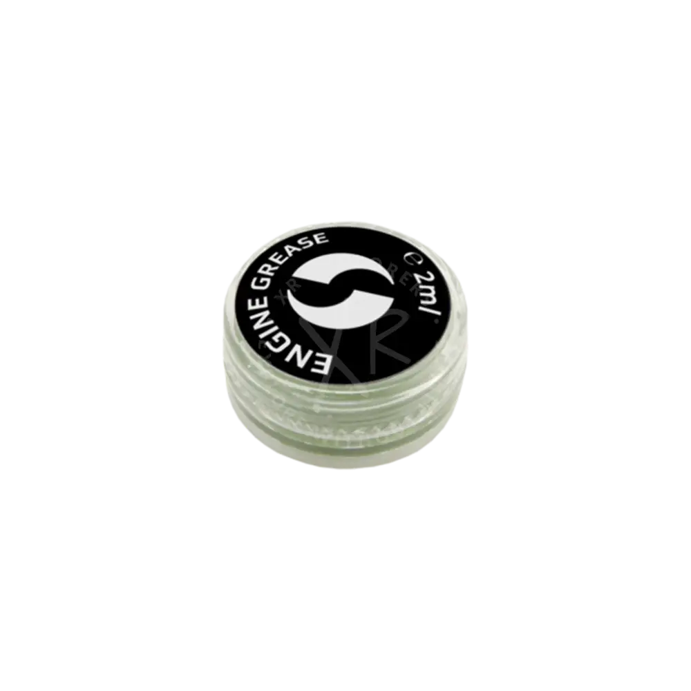 A small clear plastic container with black lid holding 2ml of go drive system grease for engine lubrication