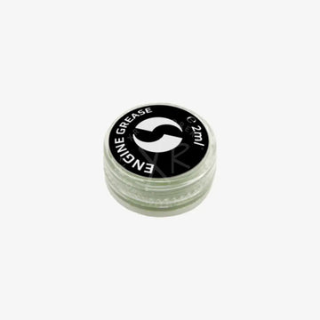 A small clear plastic container with black lid holding 2ml of go drive system grease for engine lubrication