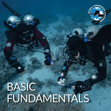 Black and red GUE Basic Fundamentals scuba diving suit with silver helmets and gear for underwater training sessions