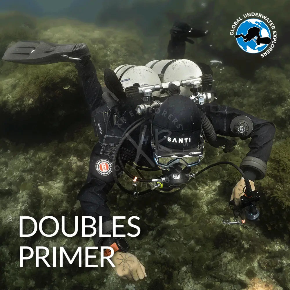 Black wetsuit with santi branding and circular logo on the arm paired with silver scuba gear with dual tanks for gue doubles primer