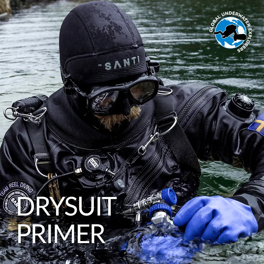 Black santi drysuit primer with blue gloves and diving gear for GUE drysuit maintenance and preparation