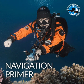 A bright orange and black scuba diving suit with matching hood and visible brand logos on the arms from GUE Navigation Primer