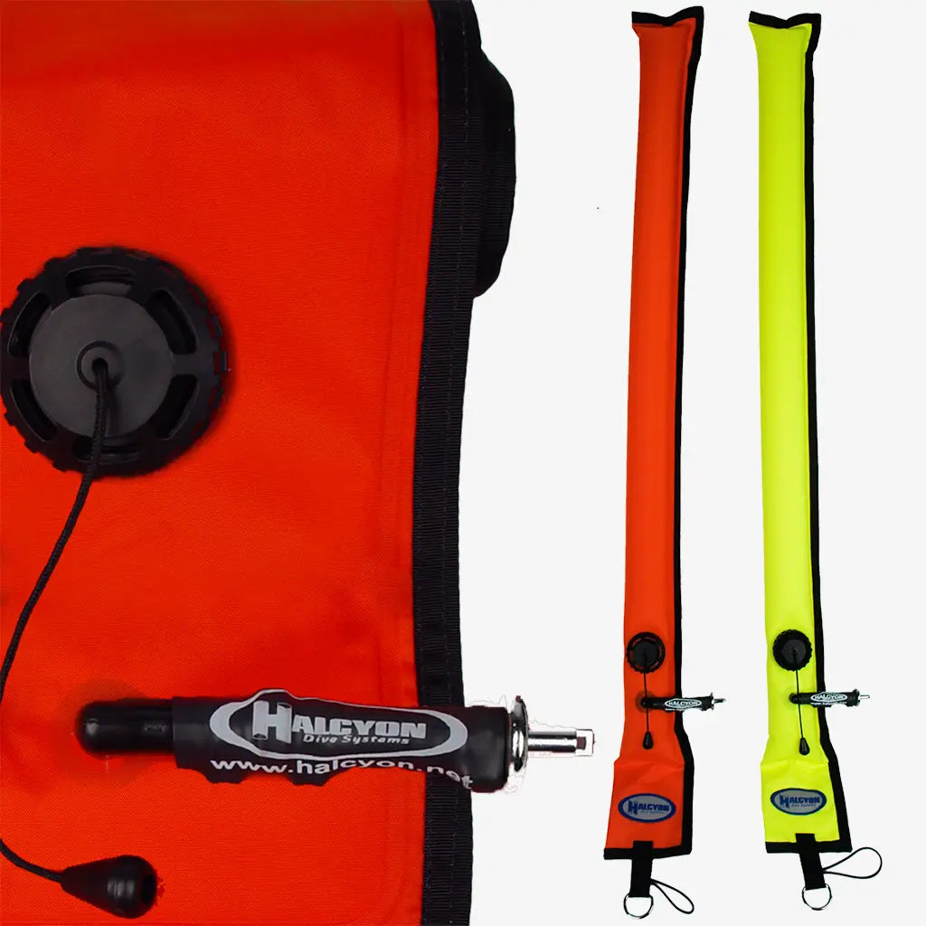 Two rolled-up halcyon closed circuit smb diver alert markers in bright orange and neon yellow with black straps and patches