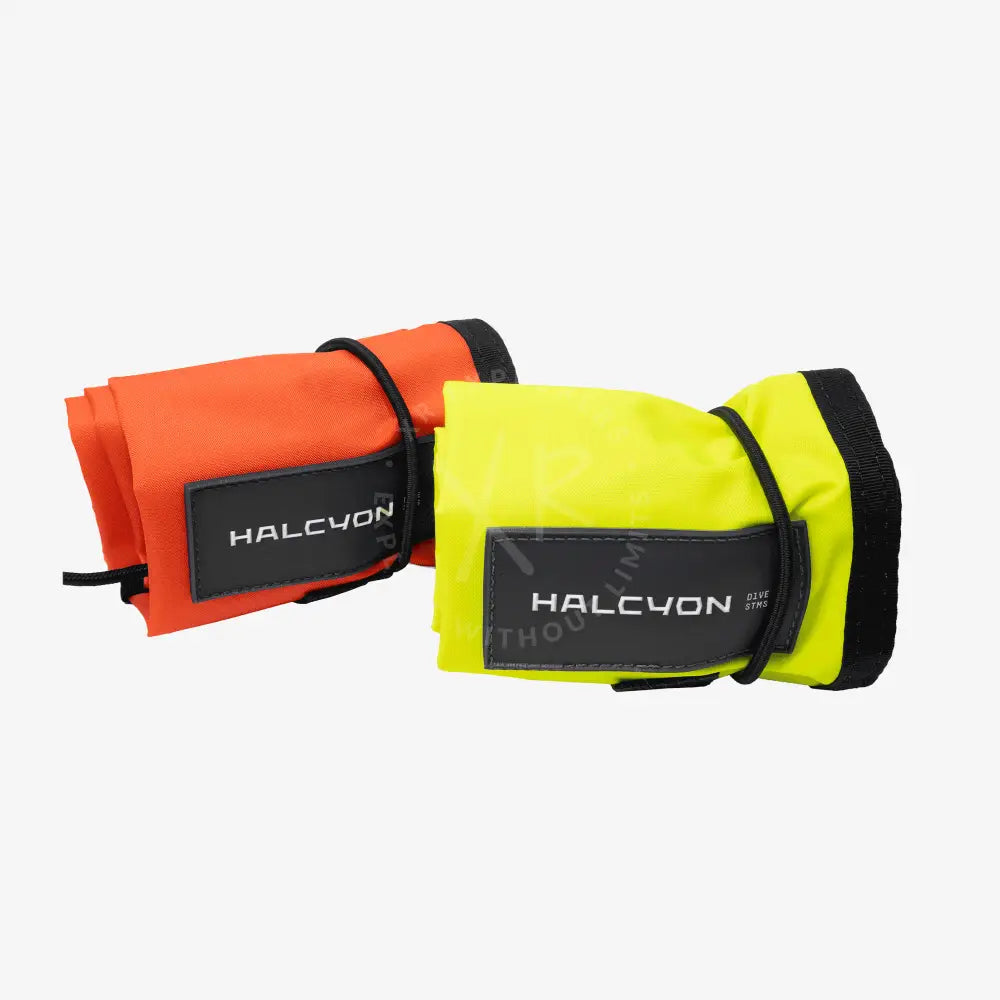 Two rolled-up halcyon closed circuit smb diver alert markers in bright orange and neon yellow with black straps and patches
