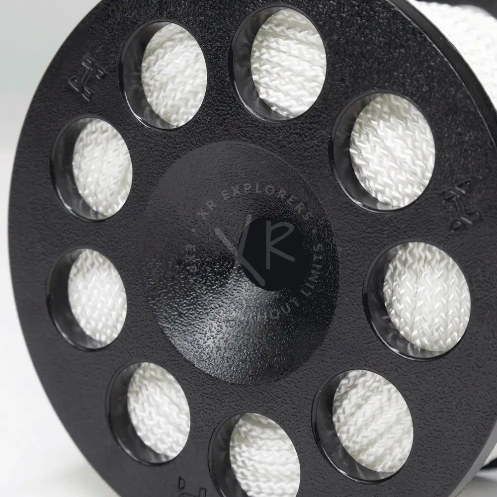 Halcyon Defender safety spool black cast iron with eight circular cutouts holding coiled white braided rope