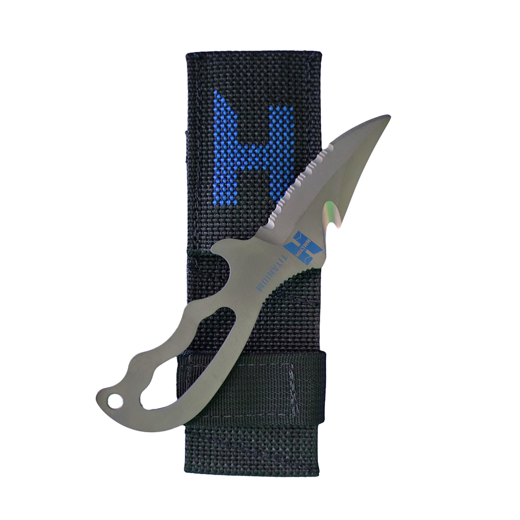 A titanium diving knife with a serrated and straight edge blade, featuring an ergonomic handle and a line cutter. The knife is accompanied by a sheath, and the blade is marked with a Halcyon logo.
