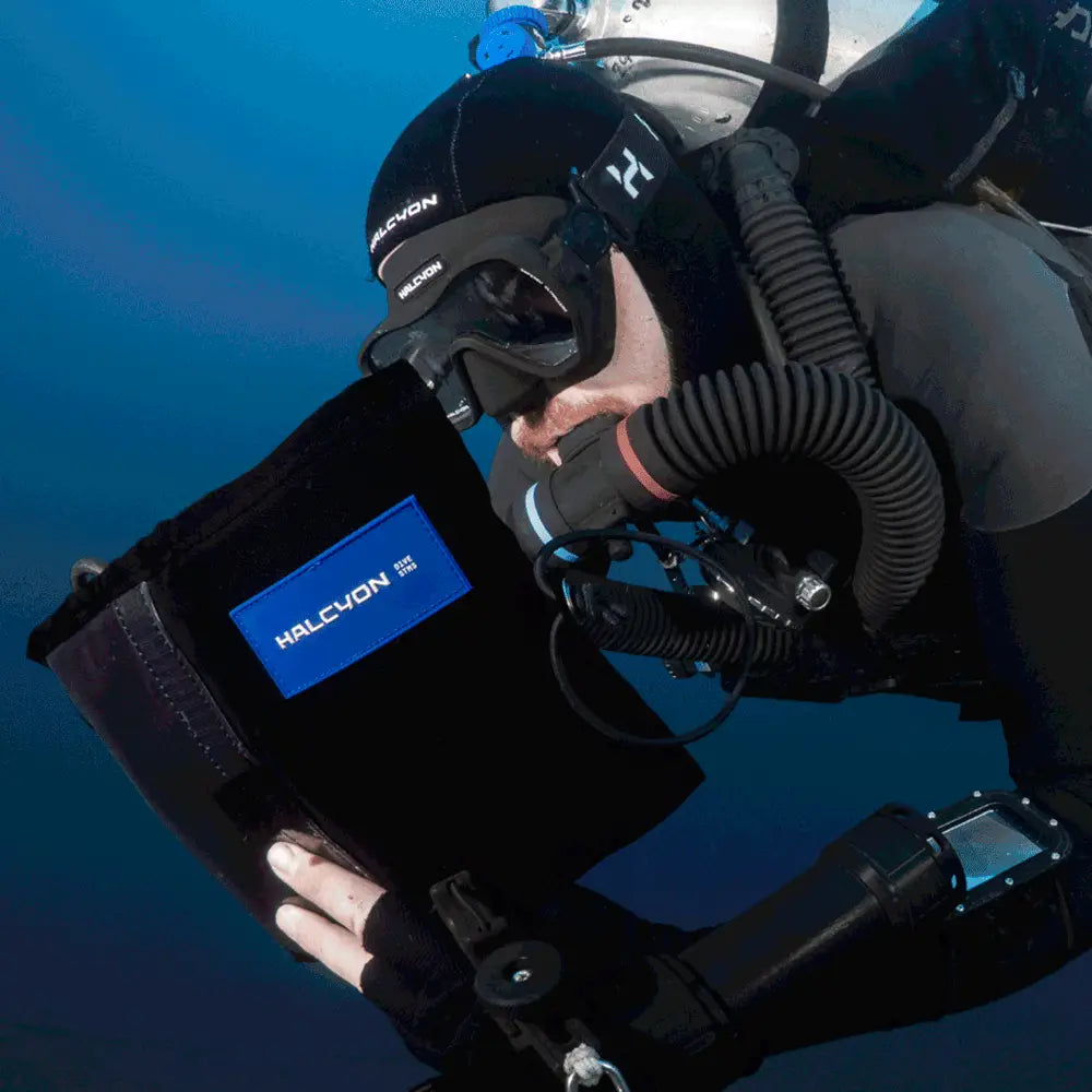 Black halcyon omnis dive mask with blue logo patch designed for underwater diving and snorkeling activities