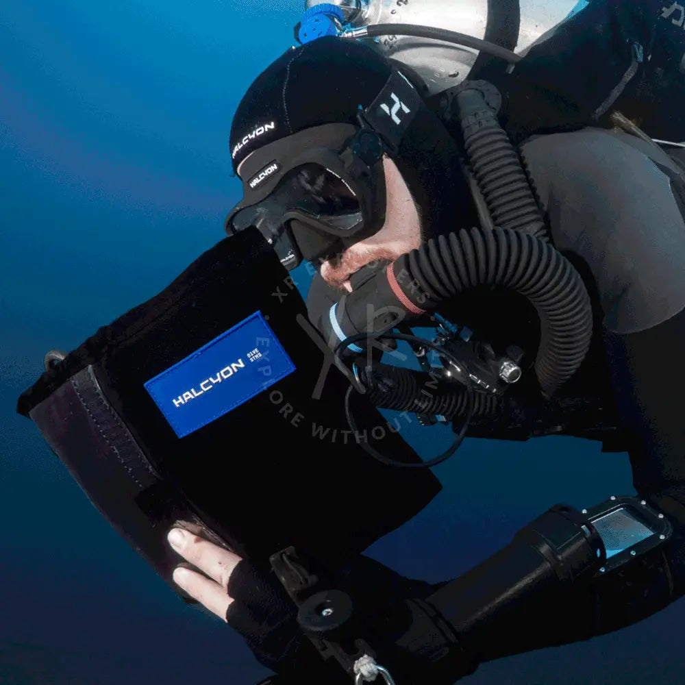 Black halcyon omnis dive mask with blue logo patch designed for underwater diving and snorkeling activities