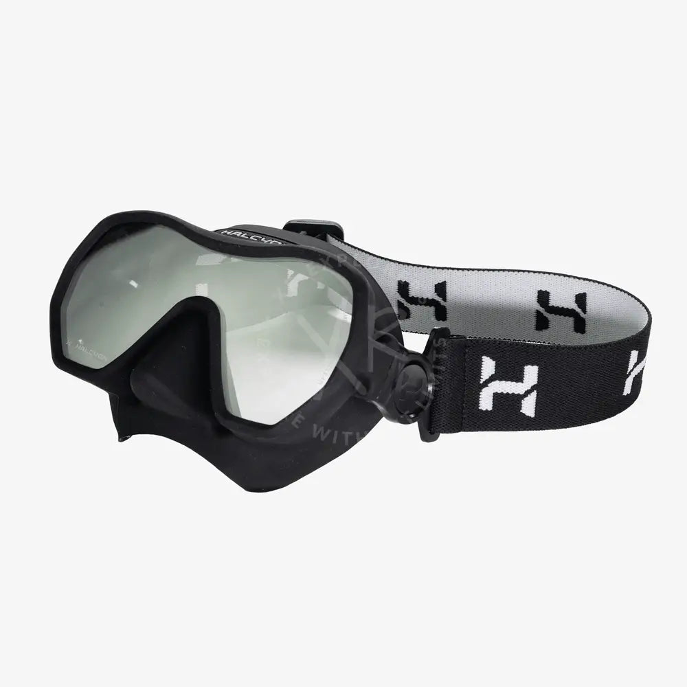 Black halcyon omnis mask with clear lenses and black and white striped adjustable head strap for diving