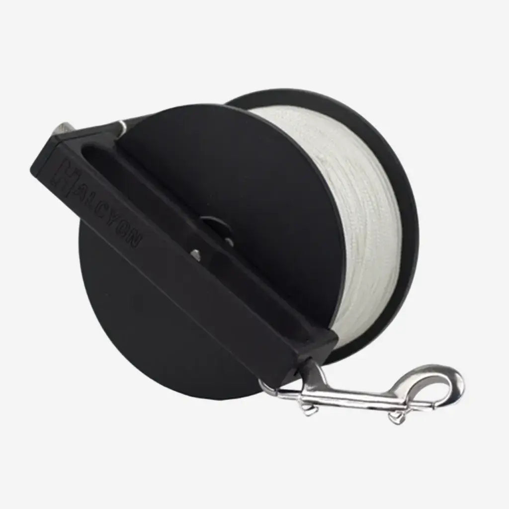 Black reel with white line and metal clip on a white background