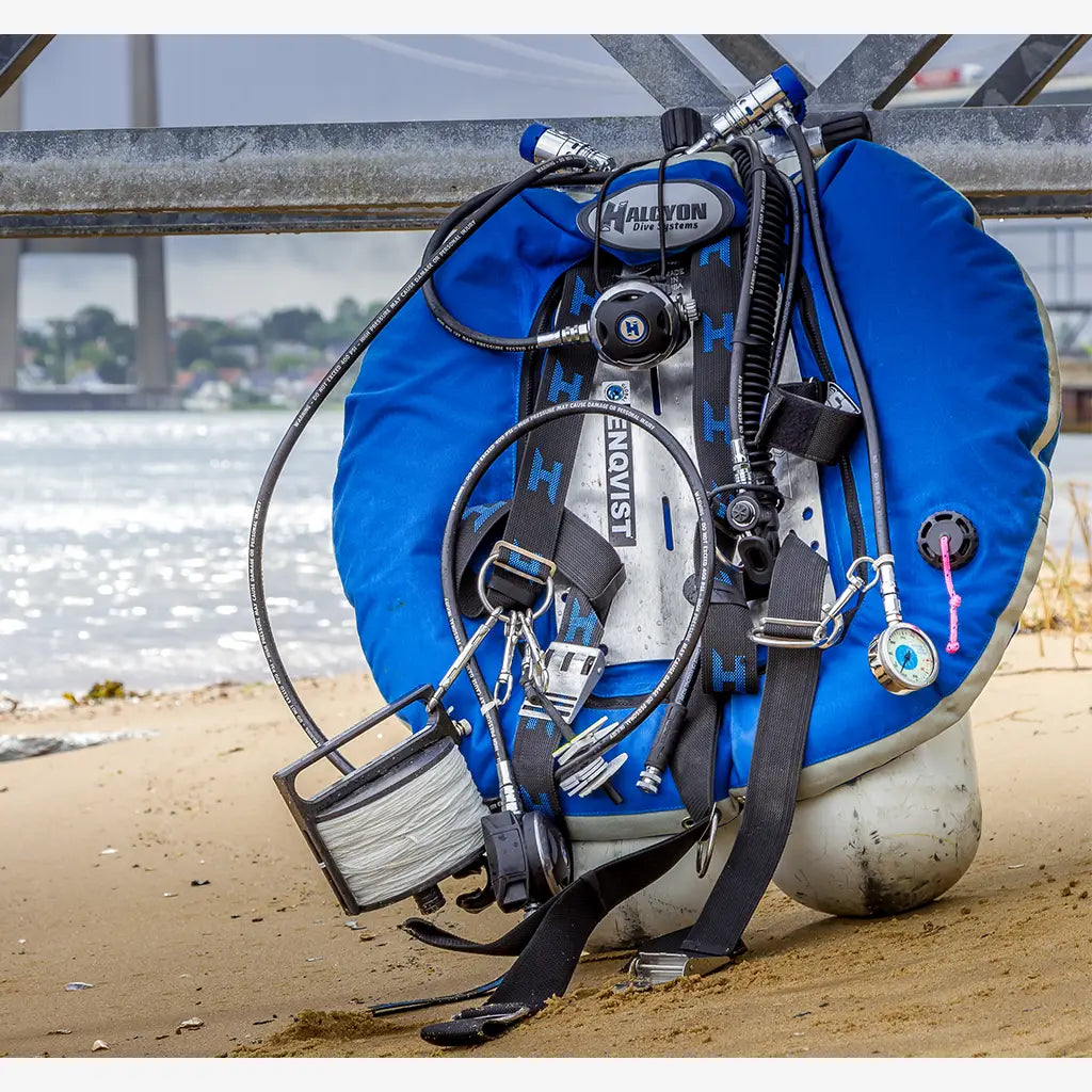 Blue halcyon dive buoyancy compensator with black straps and silver hardware shown on the back side for diving use