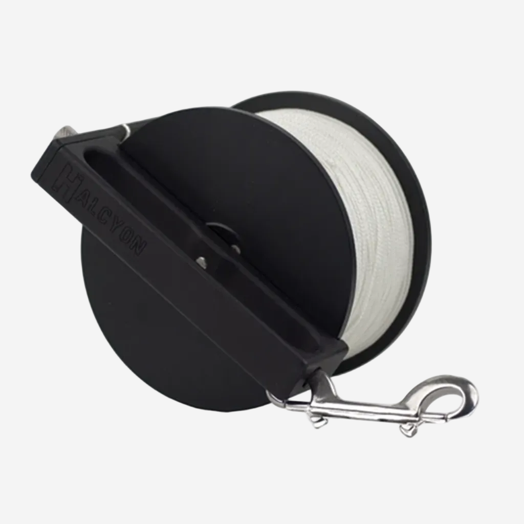 Black reel with white line and metal clip on a white background