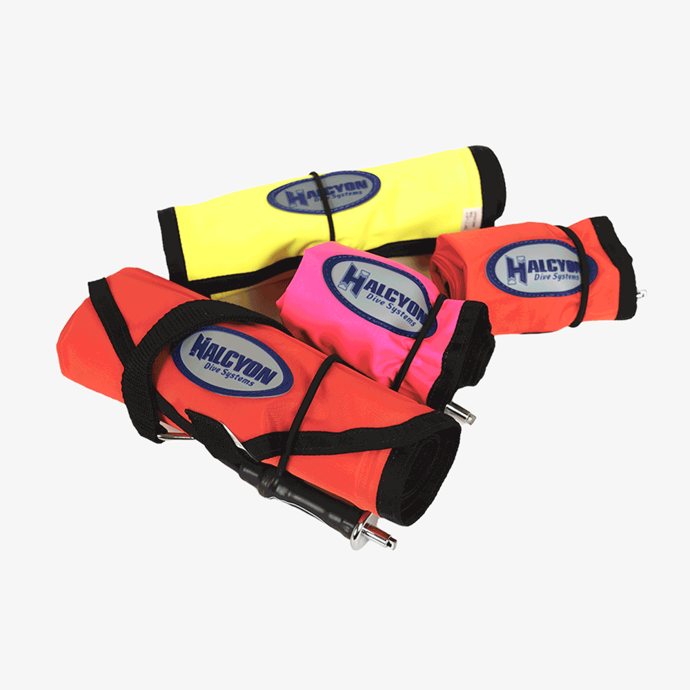 Three Halcyon SMB (Scuba Mirror Bags) laid out, with two in yellow and pink and one in black and red.
