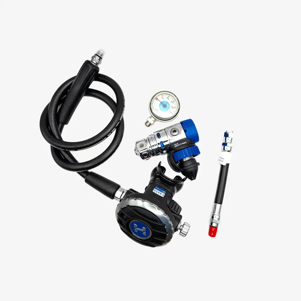 A scuba diving regulator kit with a black hose, black and silver regulator, blue and silver valve, a pressure gauge, and a red/black test tube, displayed on a light gray background.