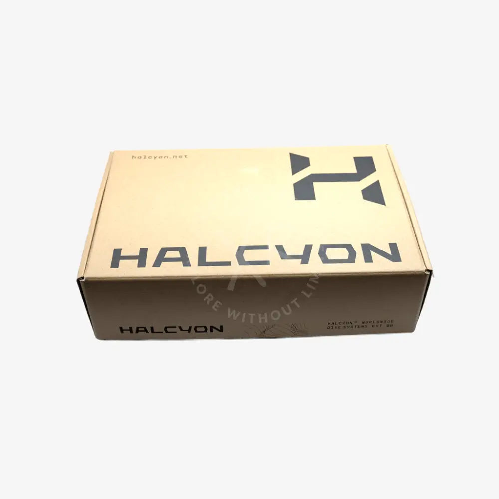 A rectangular cardboard product box for HALCYON, featuring a light beige top panel with a dark gray stylized logo and the brand name 'HALCYON' in dark gray, and a darker brown side panel with the brand name 'HALCYON' printed in black.