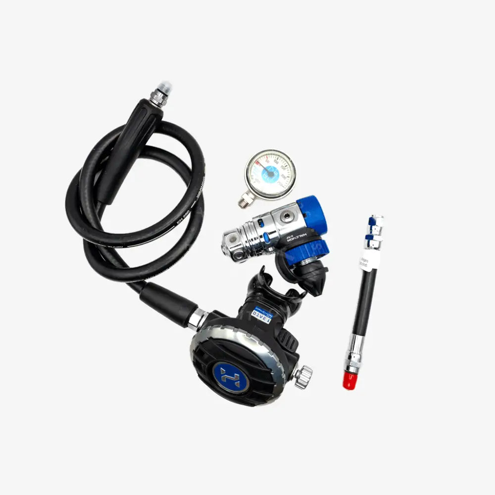A scuba diving regulator kit with a black hose, black and silver regulator, blue and silver valve, a pressure gauge, and a red/black test tube, displayed on a light gray background.