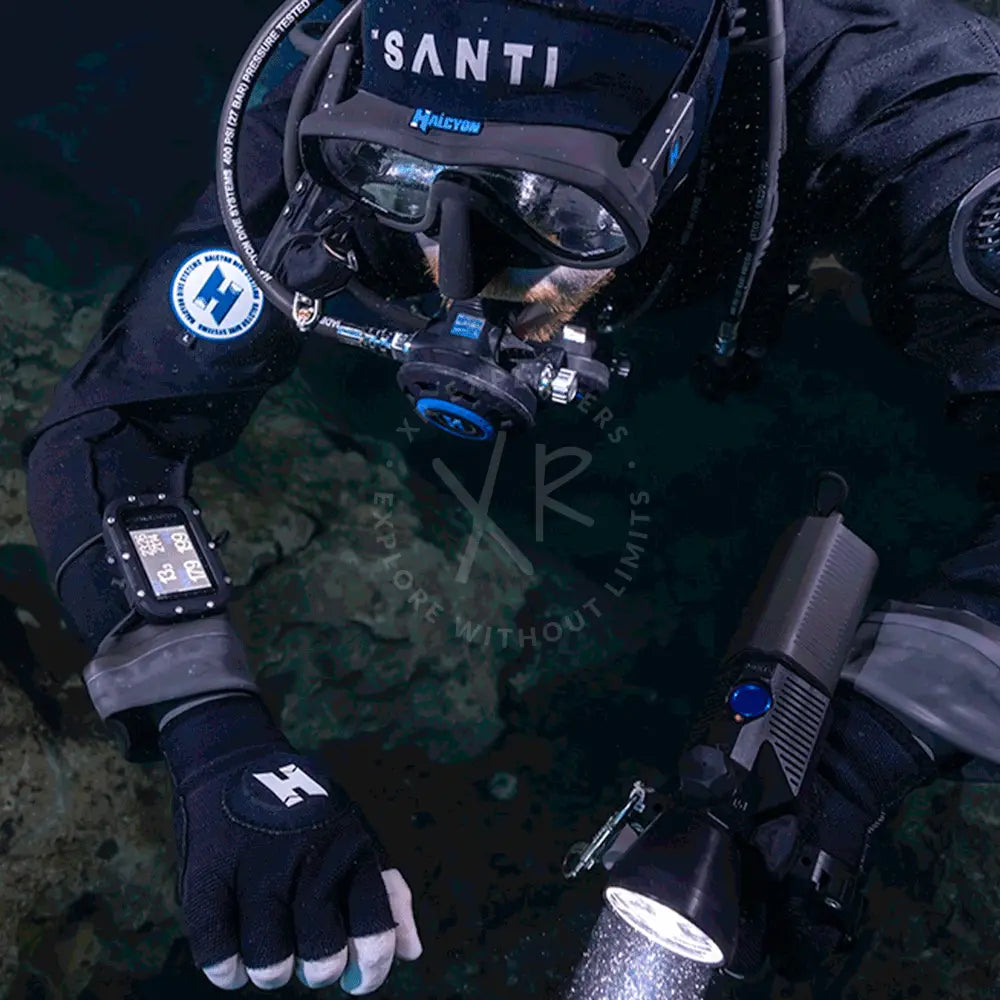 Diver in scuba gear with equipment on a dark underwater background