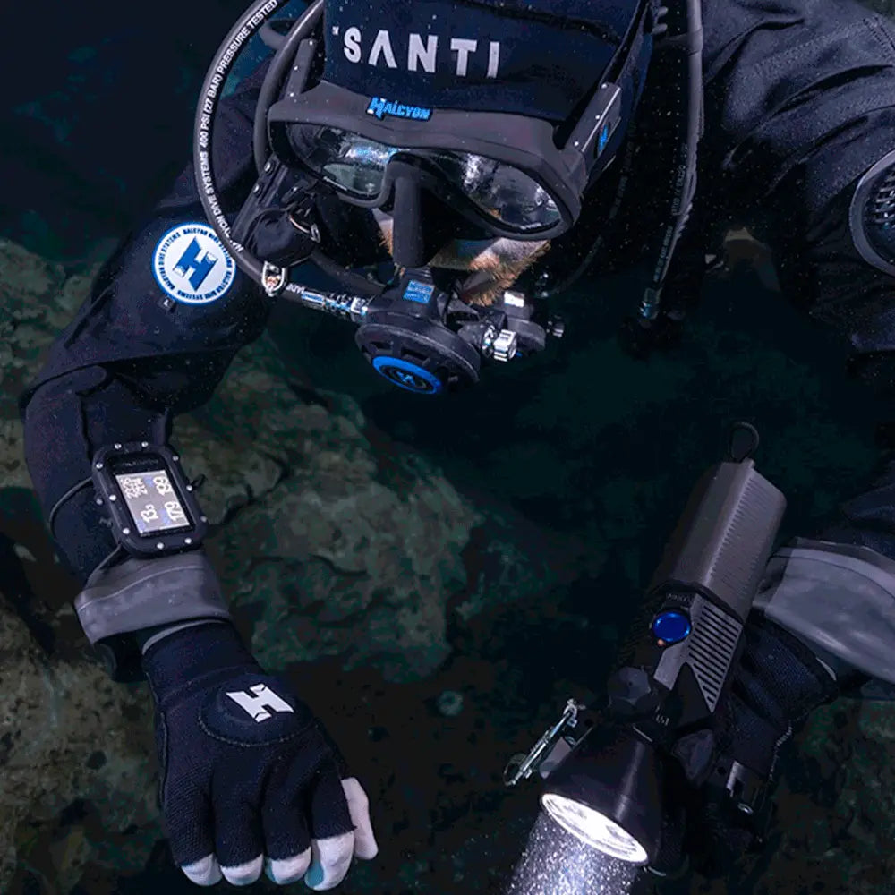 Diver in scuba gear with equipment on a dark underwater background