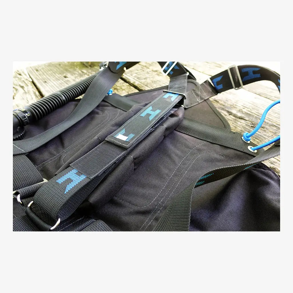Black halcyon zero gravity weight pouch diving vest with blue logo accents and adjustable straps visible from the back