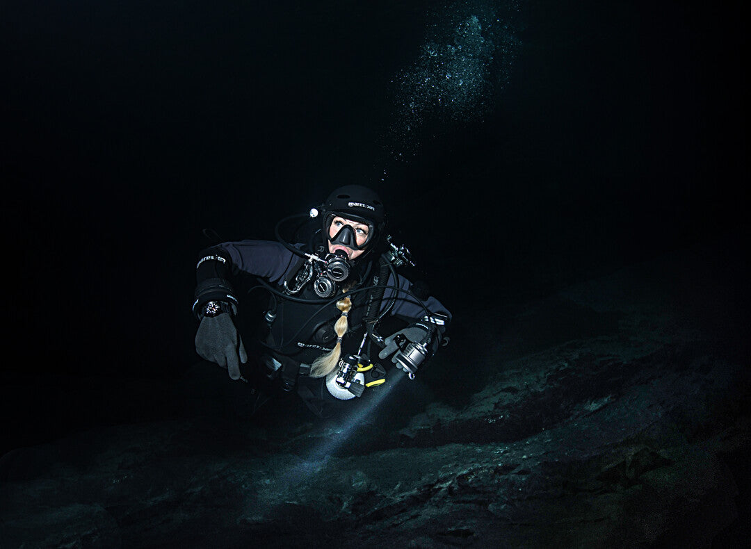 Scuba divers practicing communication and navigation in low visibility water in Saudi Arabia