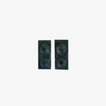 Black rectangular speakers with two circular drivers each designed as rubber buttons for steering module use