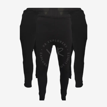 A pair of black Polartec pants designed for thermal regulation and compatibility with drysuit diving equipment.