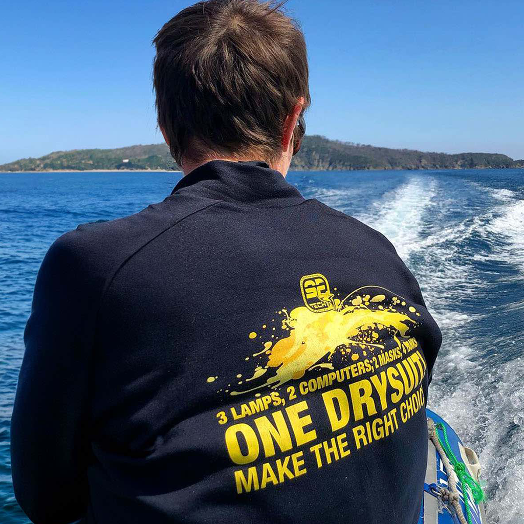 Person on a boat wearing a shirt with text and graphics.