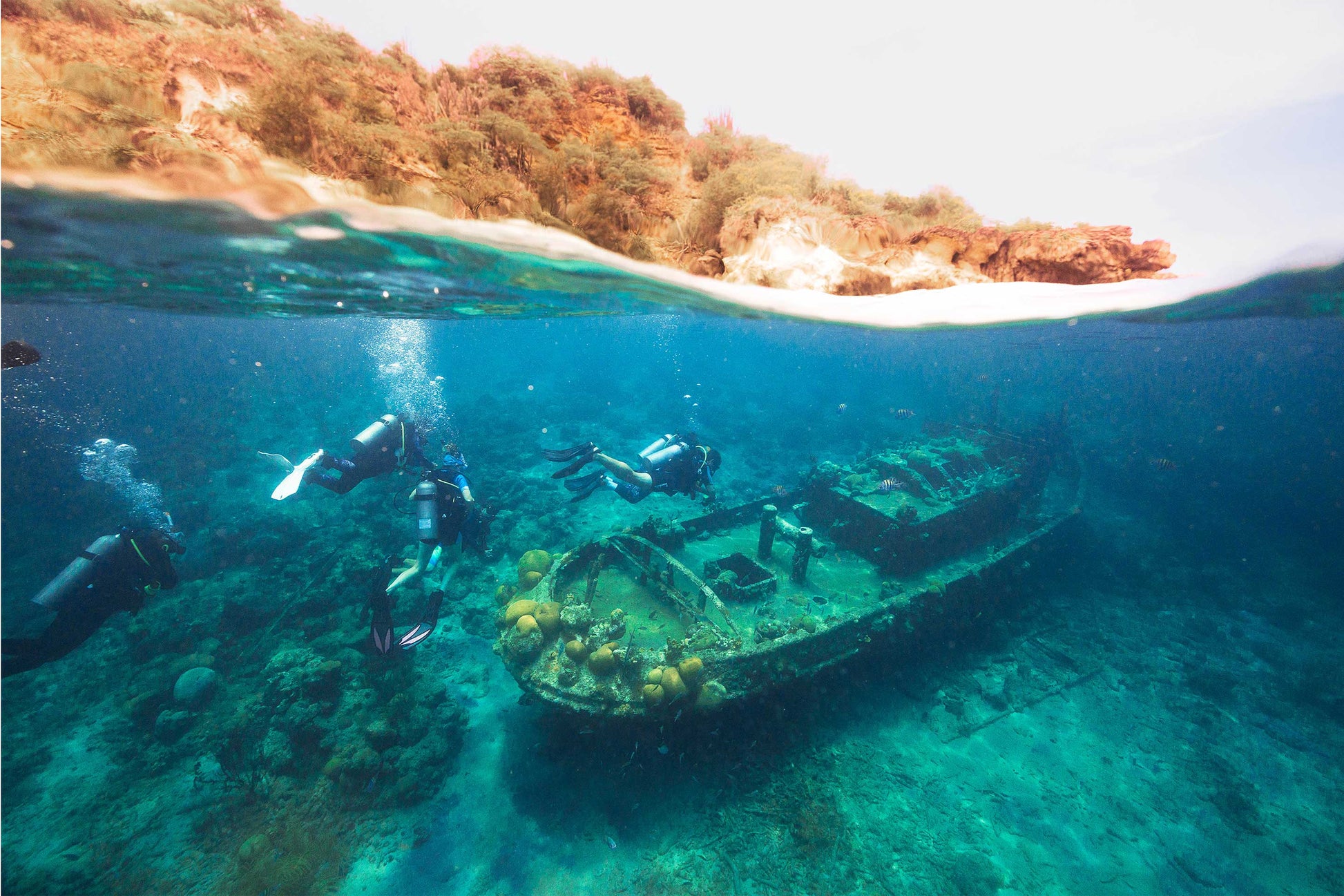 Scuba divers performing an external survey of a sunken ship in Dubai UAE with XR Explorers