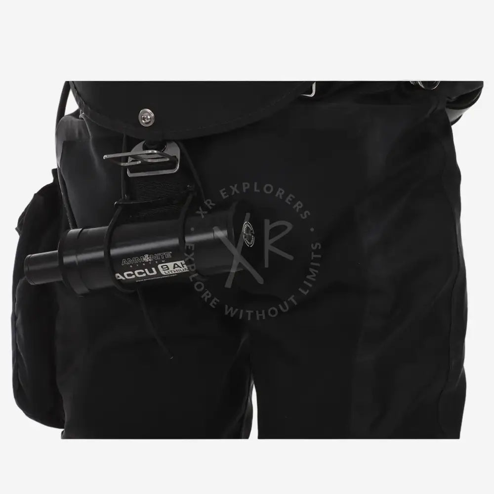 Black backpack with a cylindrical device attached on a white background