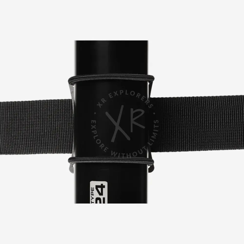 Black cylindrical object with a strap wrapped around it on a white background