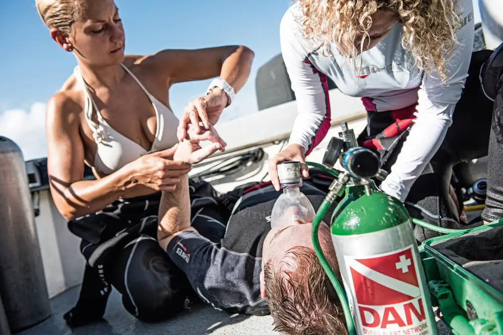 Divers performing in water rescue breathing and equipment removal in Saudi Arabia KSA