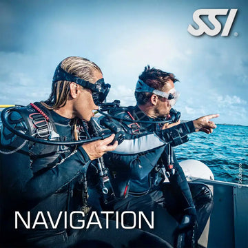 Two divers in underwater gear on a boat, with one pointing forward and the other looking at a compass, with the text 'NAVIGATION' and 'SSI' visible.