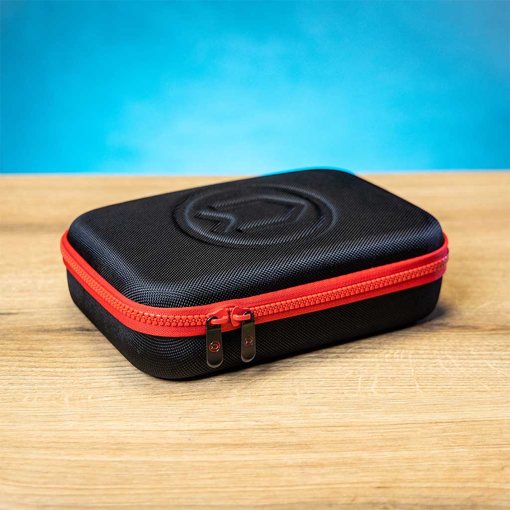 A semi-hard zipper case with a black body and red detailing, designed for storing the Divesoft Analyzer He/O₂.
