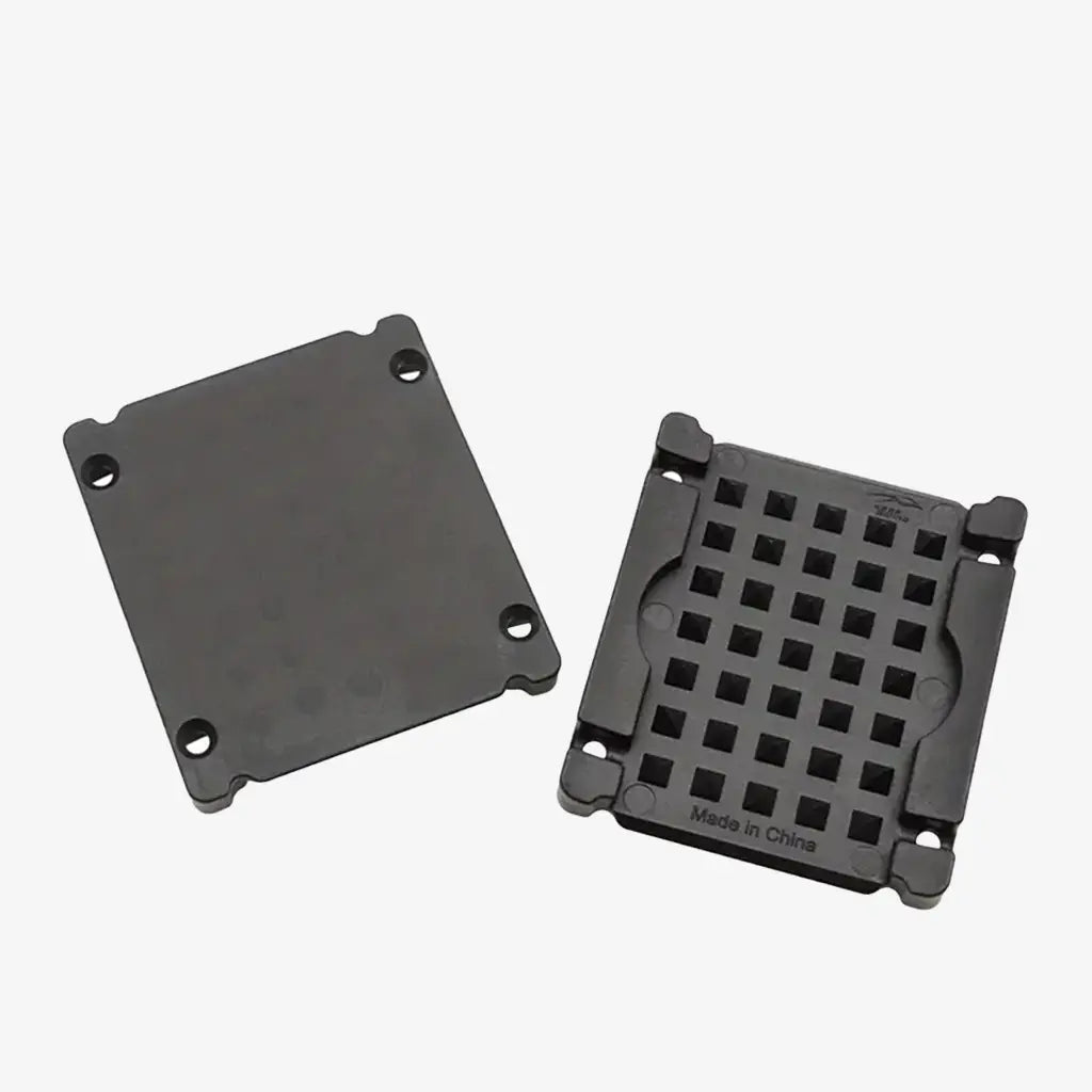 Black plastic weight fixing plate with grid pattern on one side and mounting holes on the back side