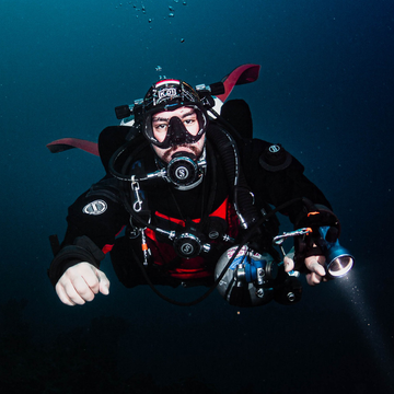 Diver wearing drysuit for thermal protection during winter diving season in Dubai