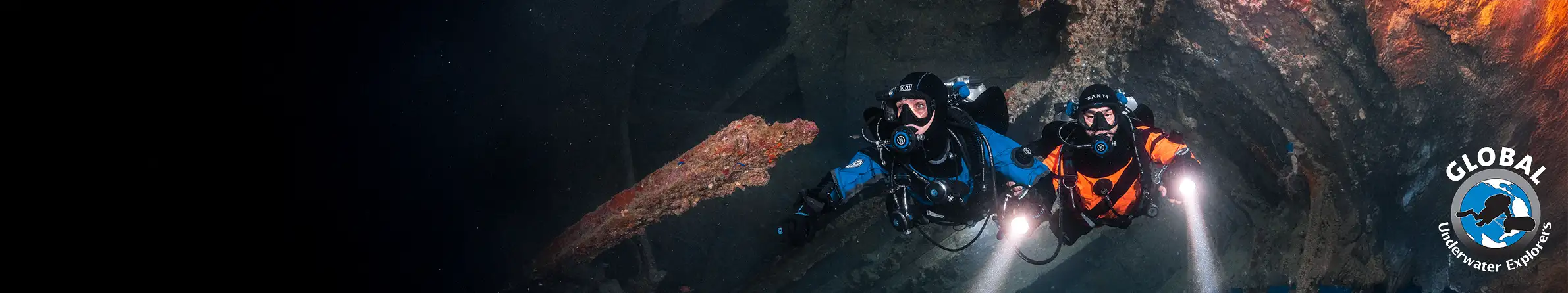 Two people in diving gear with lights exploring a cave, with 'Global Speleo' logo on the right.